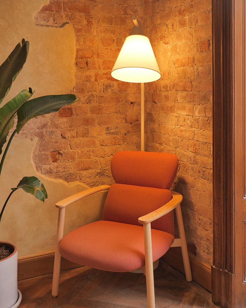 tall lamp overlooking arm chair