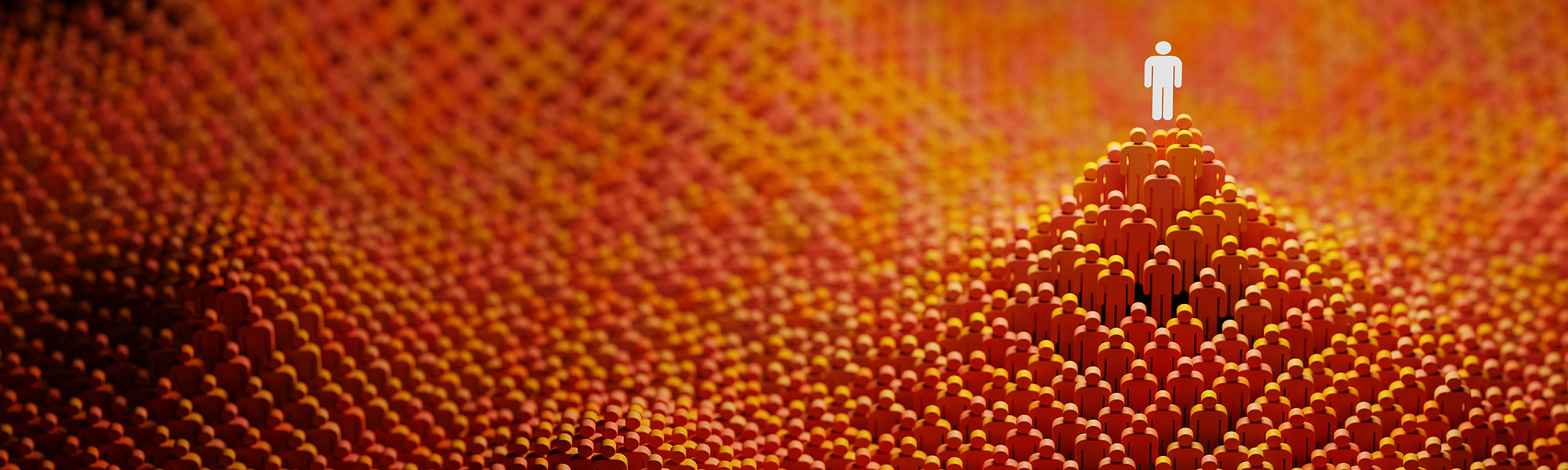 white figure standing at the top of a mountain of orange figures