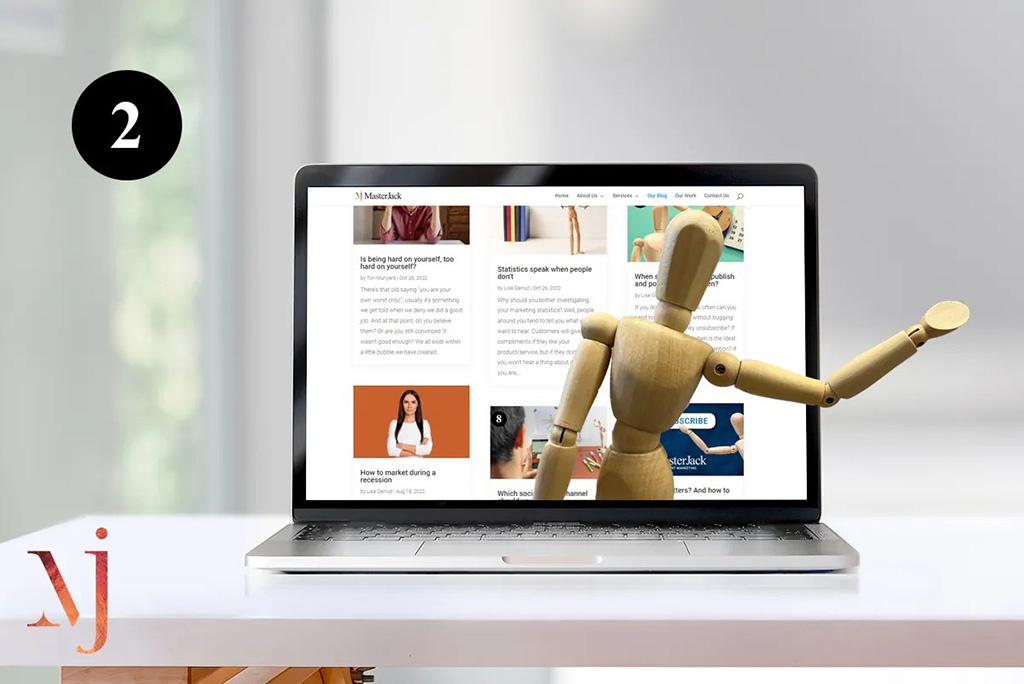 wooden mannequin popping out of website on laptop