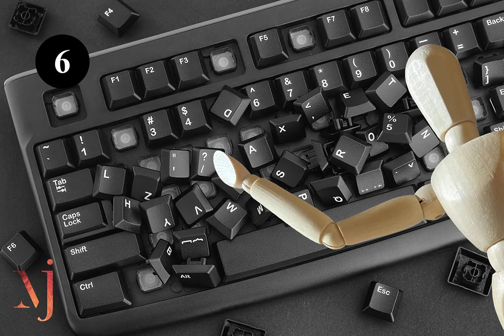 wooden mannequin pointing to broken keyboard