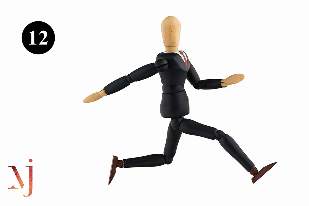 wooden mannequin dressed in a business suit running