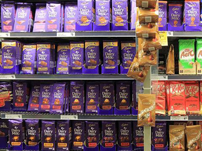 grocery store shelves filled with cadbury chocolate bars
