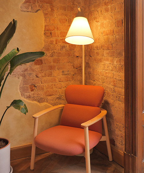 bright lamp hanging over armchair