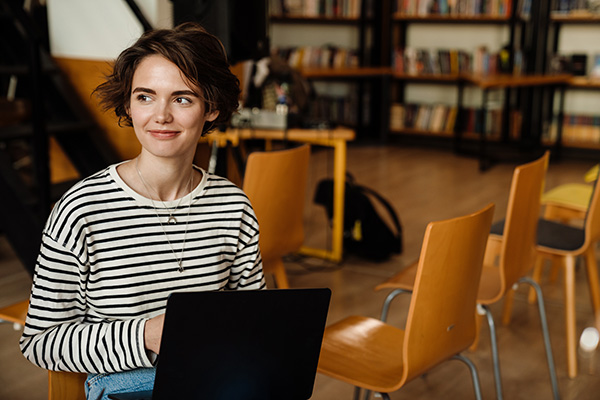 woman working on laptop in library