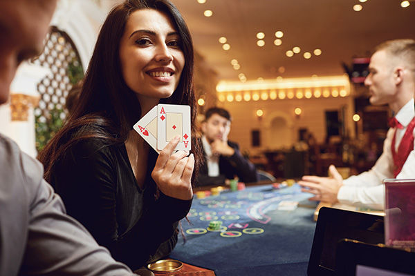 woman playing poker holding two aces