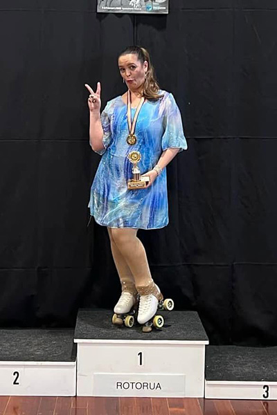 Lisa posing on the podium with her trophy at Rotorua Skating comp