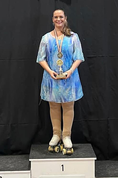Lisa standing on the podium with her award at the Rotorua Skating competition