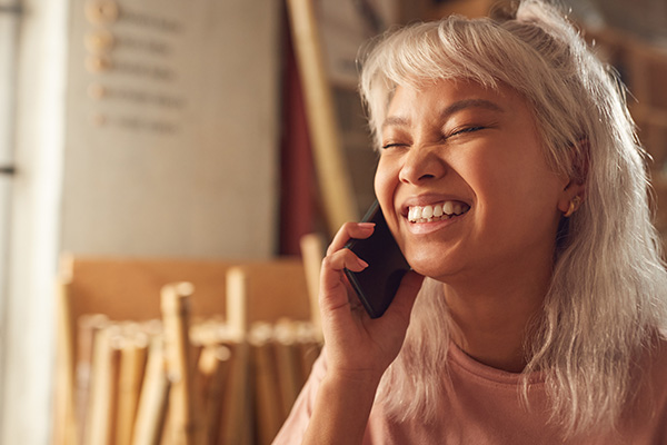 smiling woman taking a phone call