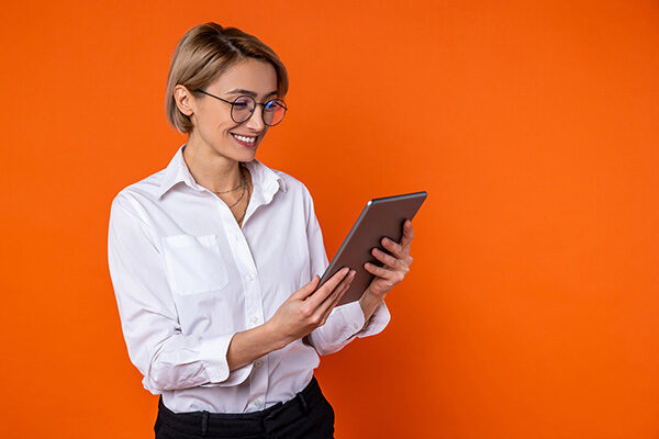happy business woman holding a tablet device