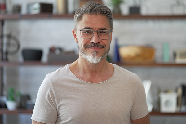 smiling middle aged man wearing glasses